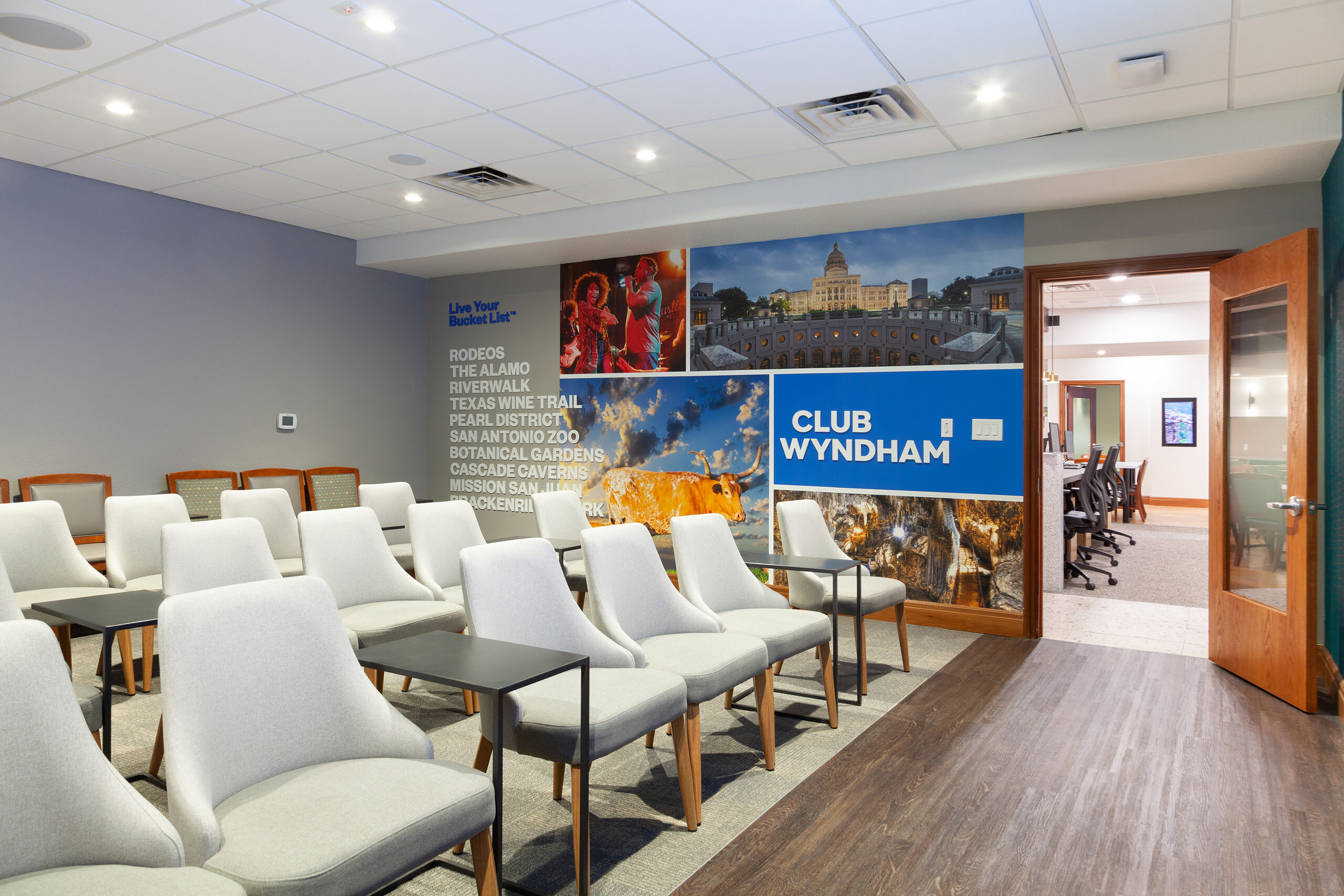 Presentation room at the La Cascada sales centre with seating and destination graphics