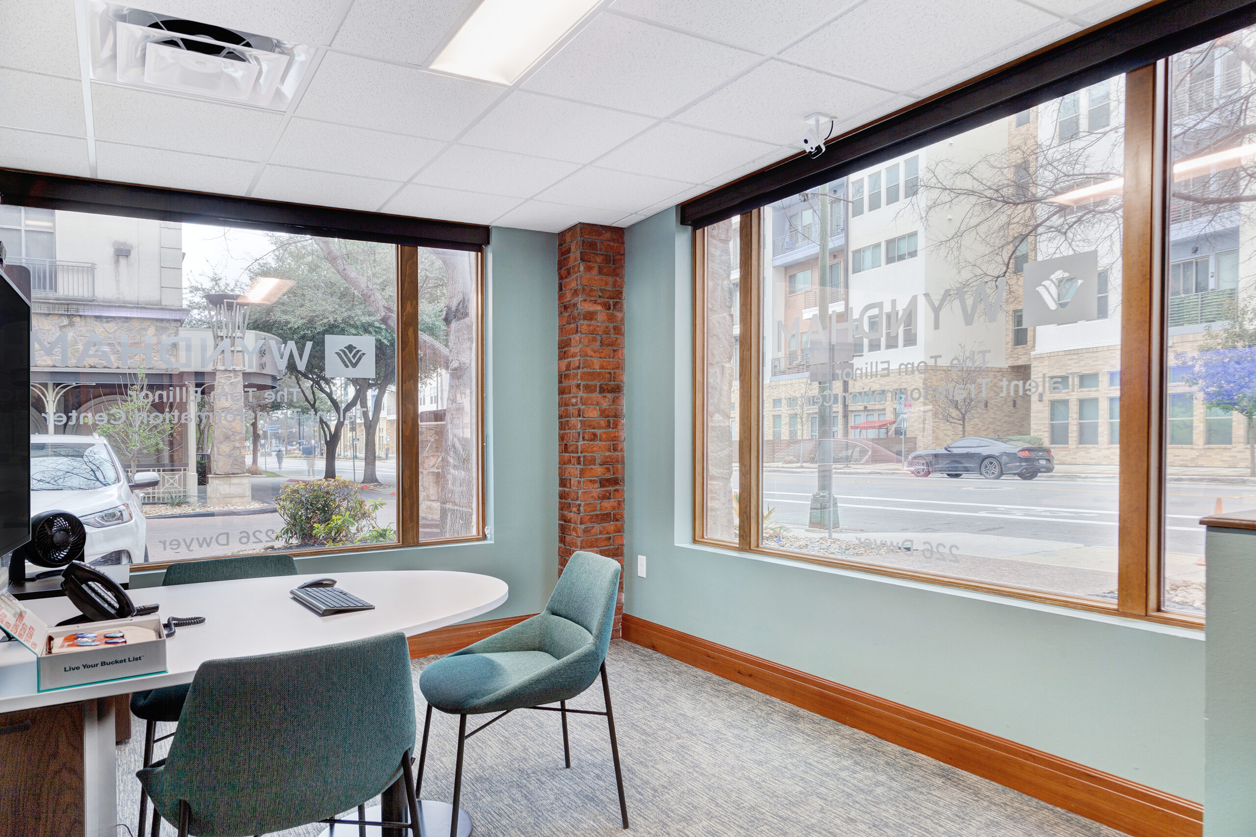 Corner meeting room at the La Cascada sales centre with full-height windows