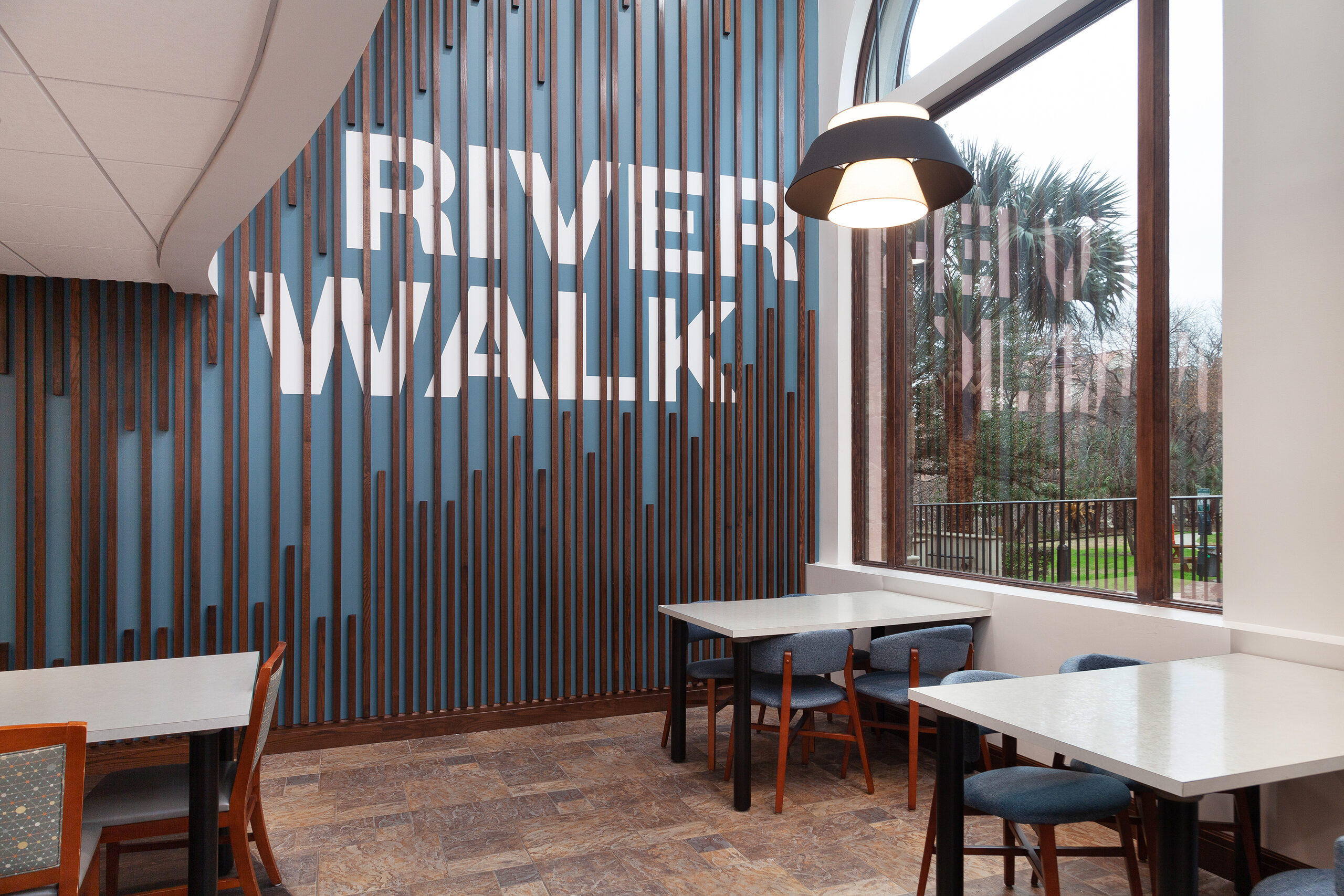 Seating area at the La Cascada sales centre beside the River Walk feature wall
