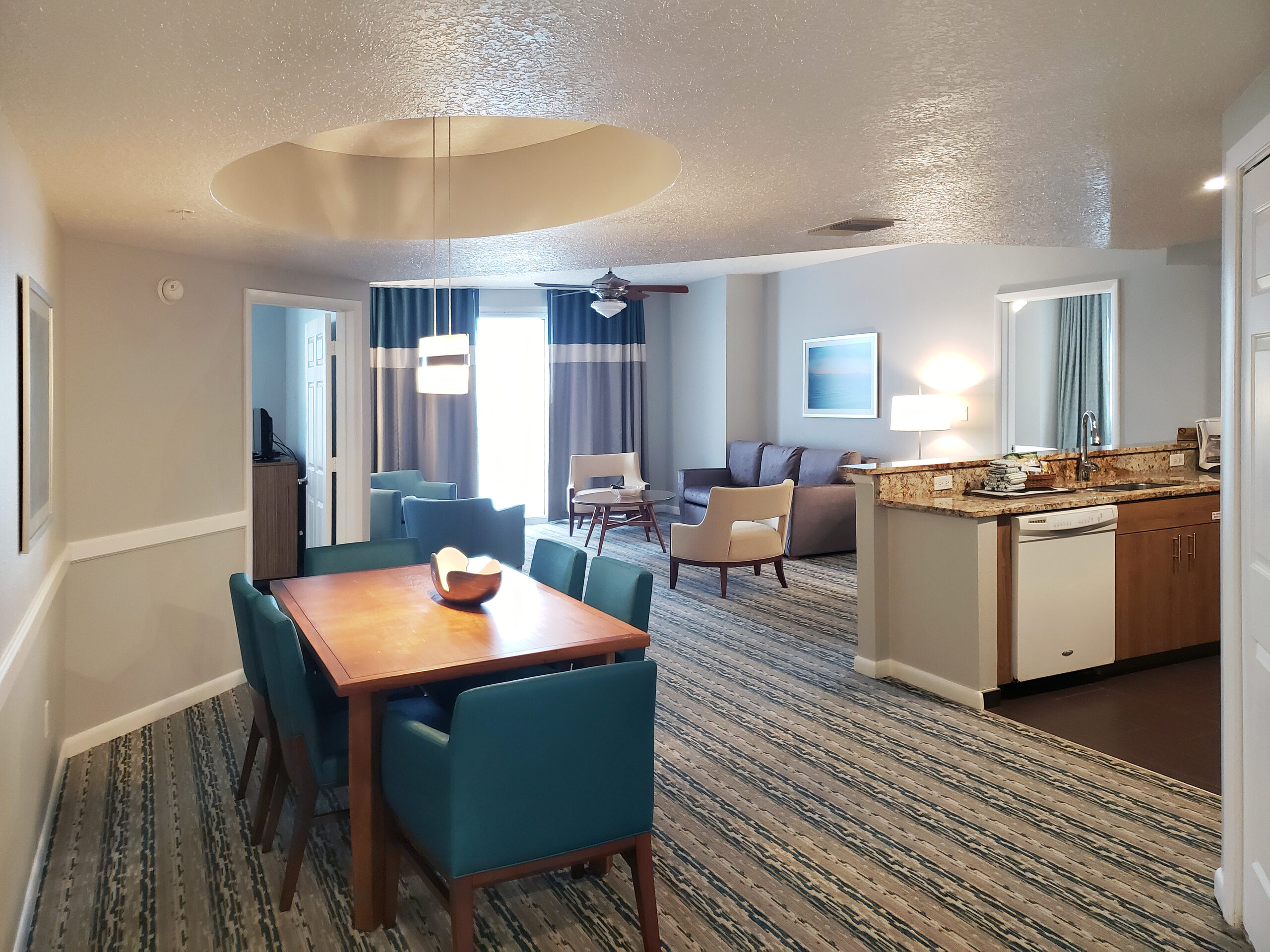 Suite living and dining area at Wyndham Ocean Walk with kitchen and balcony