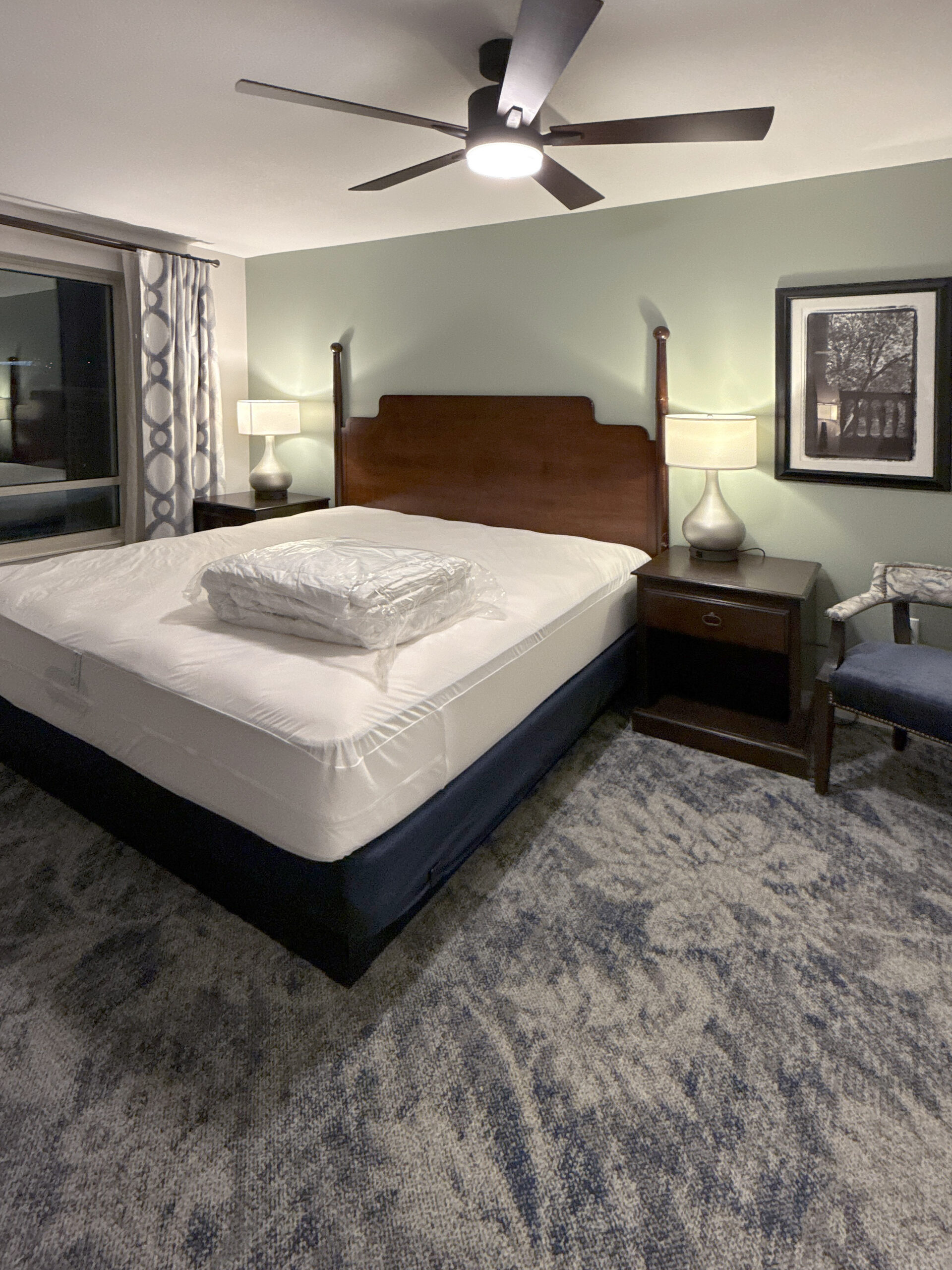 Renovated guestroom at Wyndham Old Town Alexandria with timber headboard and ceiling fan