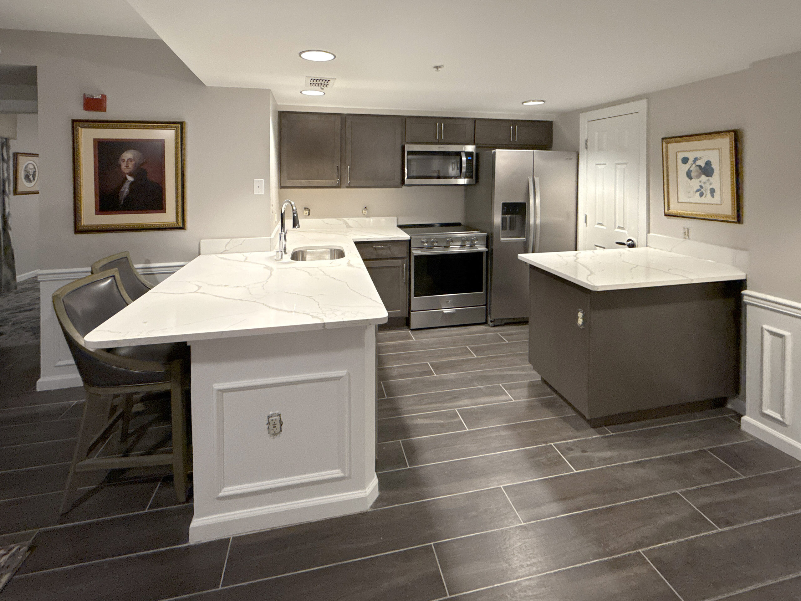 Renovated suite kitchen at Wyndham Old Town Alexandria with island seating and stone counters