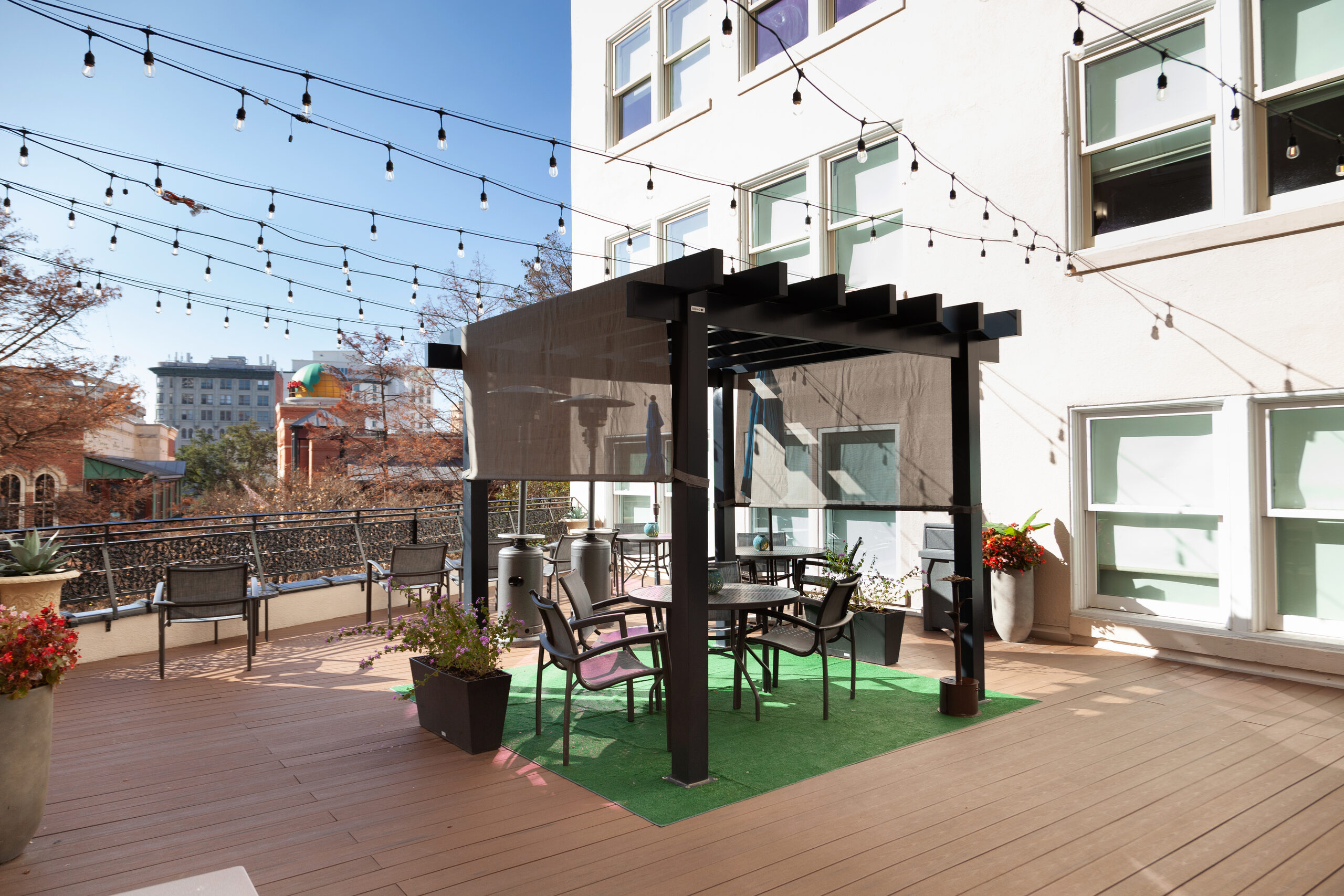 Rooftop terrace at Wyndham Riverside Suites with pergola, string lights and lounge seating