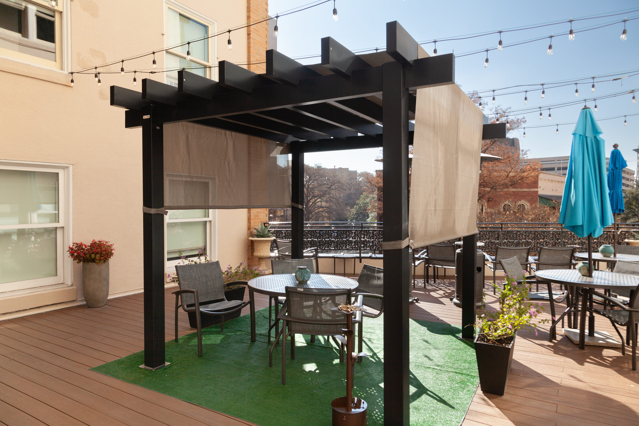 Terrace deck at Wyndham Riverside Suites with pergola, cafe tables and shade umbrella