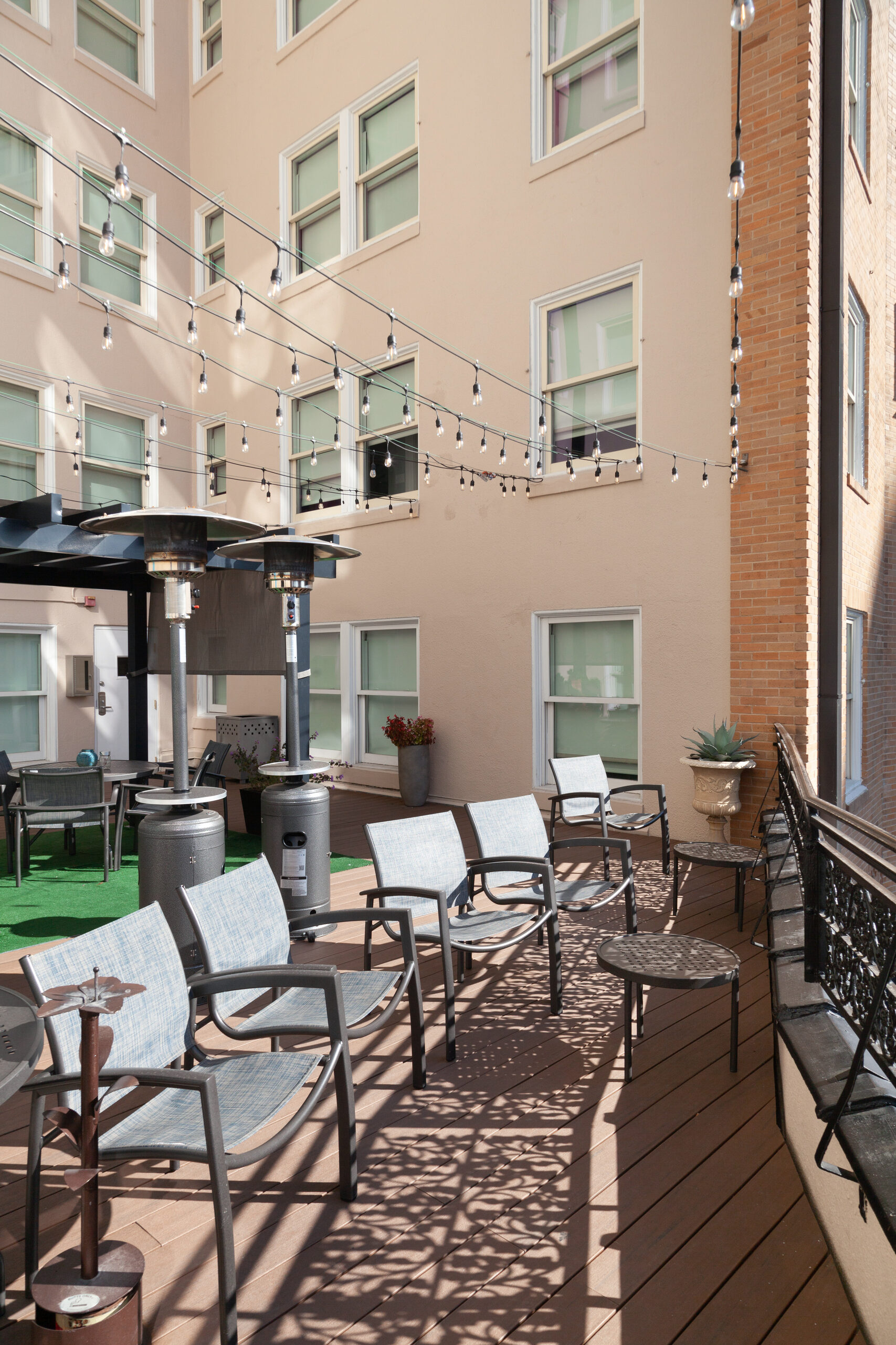 Courtyard terrace at Wyndham Riverside Suites with patio seating and overhead string lights